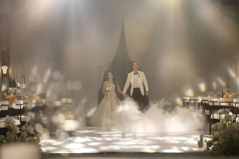 Couple at a candlelit entrance in evening mist
